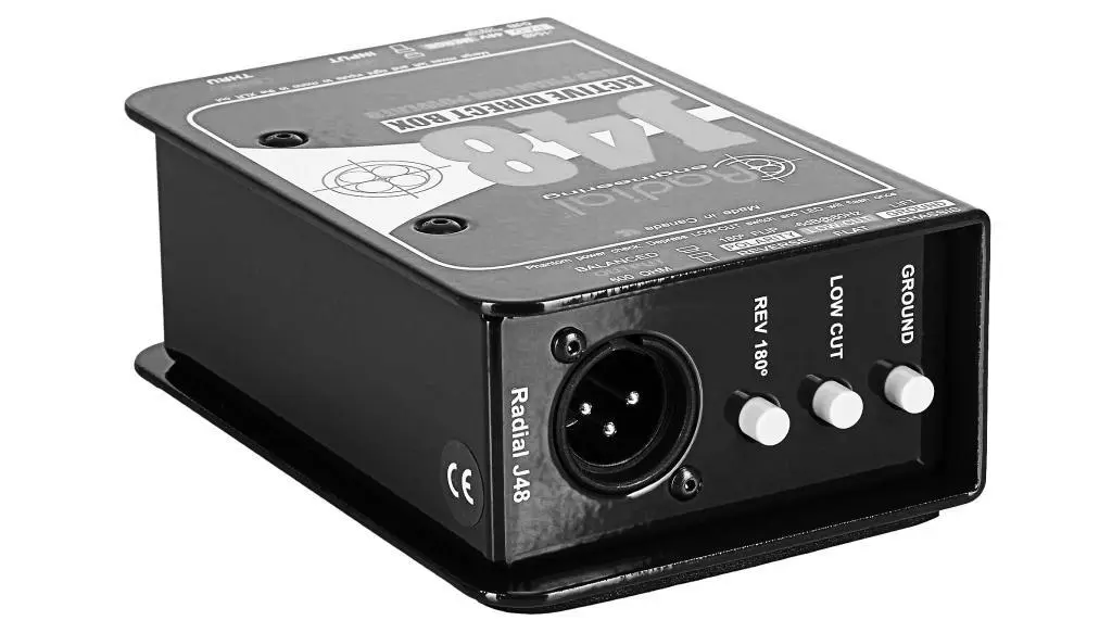 This image features a Direct Injection (DI) box often used in bass tracking. The robust casing houses essential connectivity ports, showcasing a vital piece of equipment that translates the bass guitar's sound for recording devices, preserving the fidelity of the bass tone.